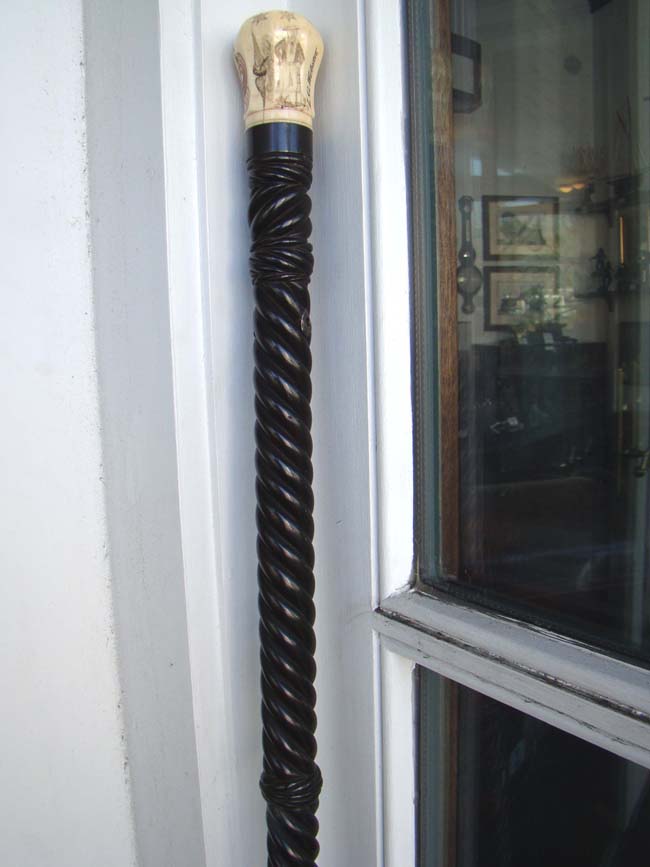 A RARE and beautiful 19th century American presentation walking stick with an eight sided scrimshawed ivory knob and a spiral twist entwined rope pattern dark rosewood shaft.